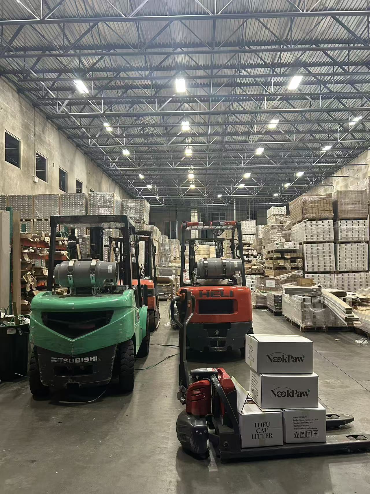 Cattus warehouse in Vancouver with forklifts and stacked pallets of NookPaw products